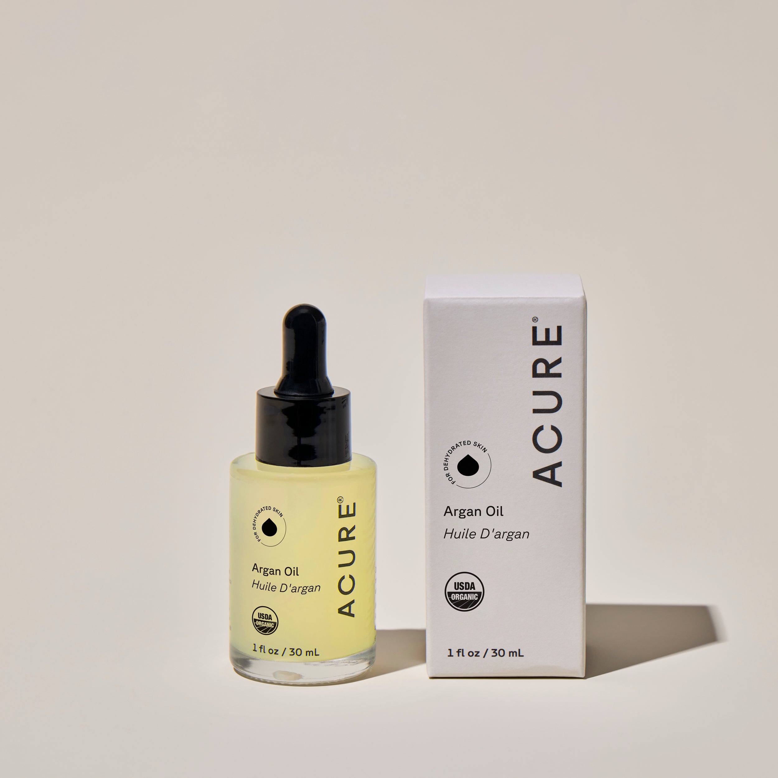 ACURE Organic Argan Oil Bottle next to a box with product details– Hydrating Multi-Use Oil for Dry Hair, Cuticles & Glowing Skin