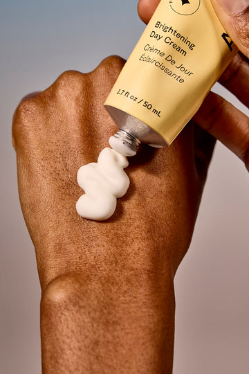 Hand close-up applying body moisturizer