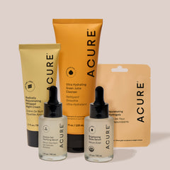 Acure skincare products including cream, cleanser, serum, and Under Eye hydrogels on a light background