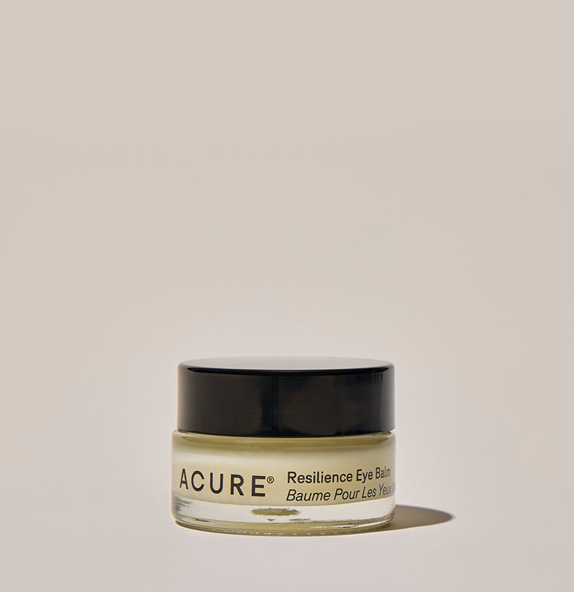 A jar of ACURE Resilience Eye Balm against a neutral background.