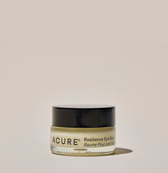 A jar of ACURE Resilience Eye Balm against a neutral background.