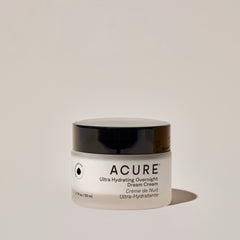 A jar of ACURE Ultra Hydrating Overnight Dream Cream against a neutral background.