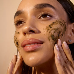 Woman applying non-toxic face scrub