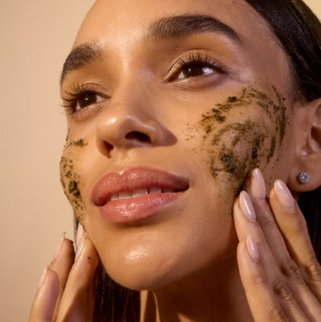 Woman applying non-toxic face scrub