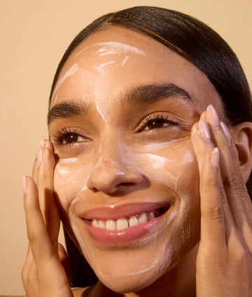 Woman applying Acure's Night mask for a rejuvenated look