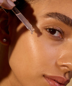 Woman applying serum - Acure's Beginners skincare routine
