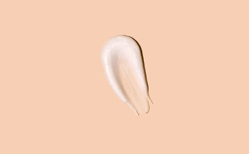 white cleanser on a pink background