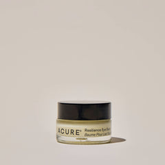 Acure Resilience Eye Balm jar on a beige background