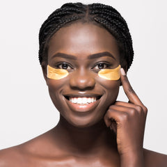 Woman applying Acure under eye hydrogels