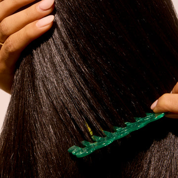 close-up of Woman combing her ultra hydrated hair