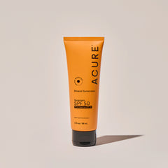 Acure Mineral Sunscreen SPF 50yellow tube, standing upright on a simple background.