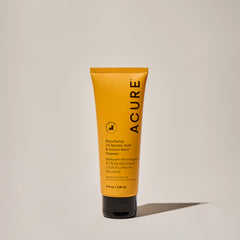A yellow tube of ACURE Resurfacing 1% Glycolic Acid & Unicorn Root Cleanser on a neutral background.
