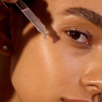 woman applying serum drops