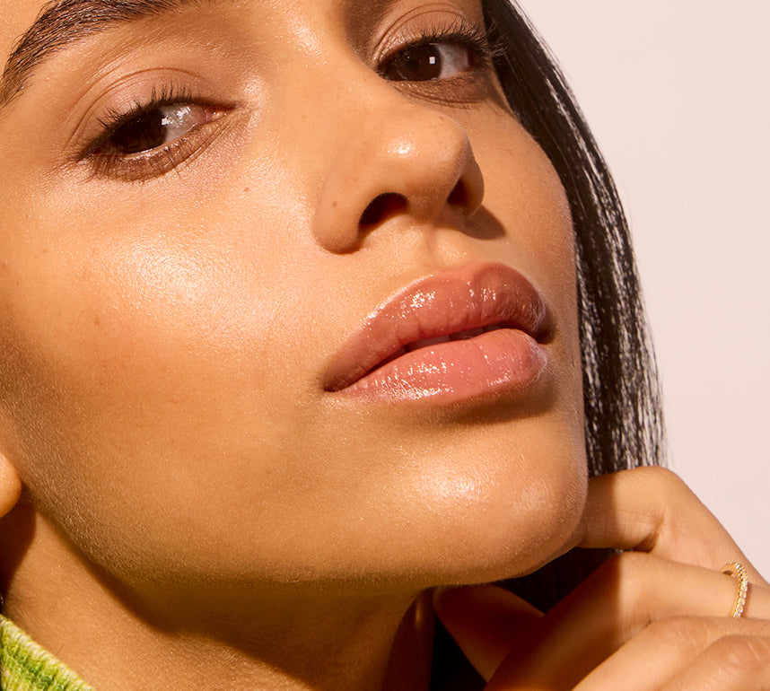 Close-up of a woman's face with a soft focus on her lips and skin.