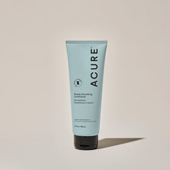 A tube of ACURE Simply Smoothing Conditioner against a neutral background.