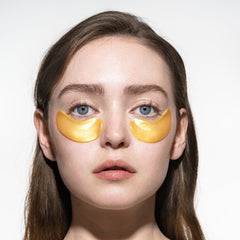Woman using a pair of ACURE RADICALLY REJUVENATING UNDER EYE HYDROGELS