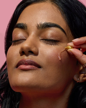 Woman applying 100% pure, cold-pressed organic argan oil.