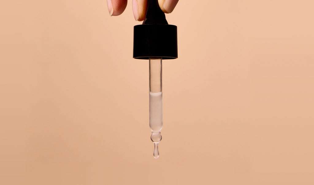 Close-up of AI-powered peptide serum dropper – brightening and smoothing serum for aging skin care routine