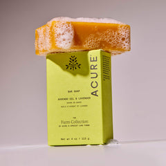 Acure bar soap with packaging on a light gray background