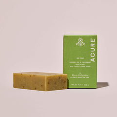 Avocado oil and peppermint Bar of soap and green packaging with 'Acure' x Apricot Lane Farm branding on a beige background