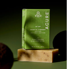 Acure Avocado oil and Peppermint bar soap with green packaging on a dark background