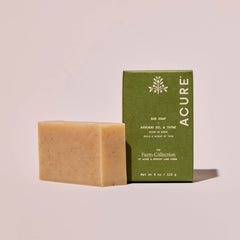 Avocado oil and thyme Bar of soap and its packaging with 'Acure' branding on a beige background