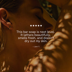 Person using bar soap with a five-star rating text overlay