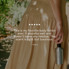 Person holding a bottle of Acure lotion with a review quote on a blurred natural background