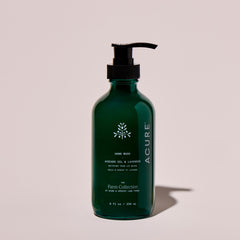 Green bottle of Acure hand wash on a beige background