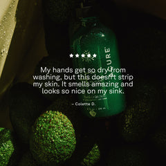 Green bottle with review text on a dark background