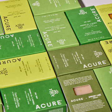 Acure soap bars and packaging arranged together