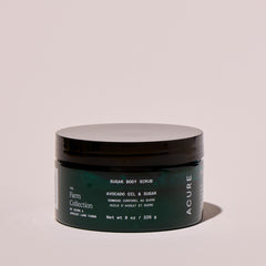 Acure Organics sugar body scrub jar on a beige background
