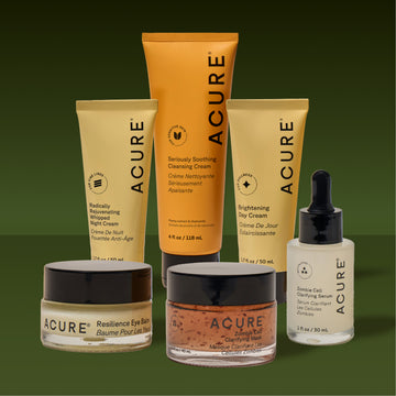 Collection of Acure skincare products on a green background