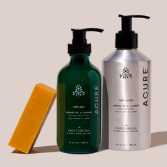 Acure Organics hand wash, body lotion, and soap bar on a beige background