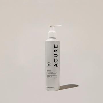 A pump bottle of ACURE Bonding Conditioner with a white label on a neutral background.