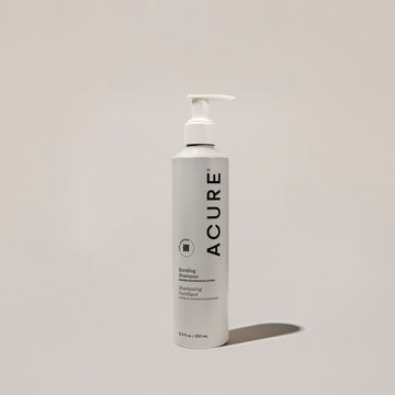 A bottle of ACURE Bonding Shampoo with a pump dispenser, positioned against a neutral background.