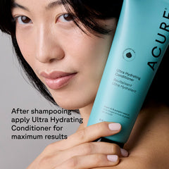Woman holding a bottle of Acure Ultra Hydrating Conditioner with text on a gray background