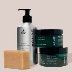 Acure skincare products including a bottle, jars, and soap on a beige background