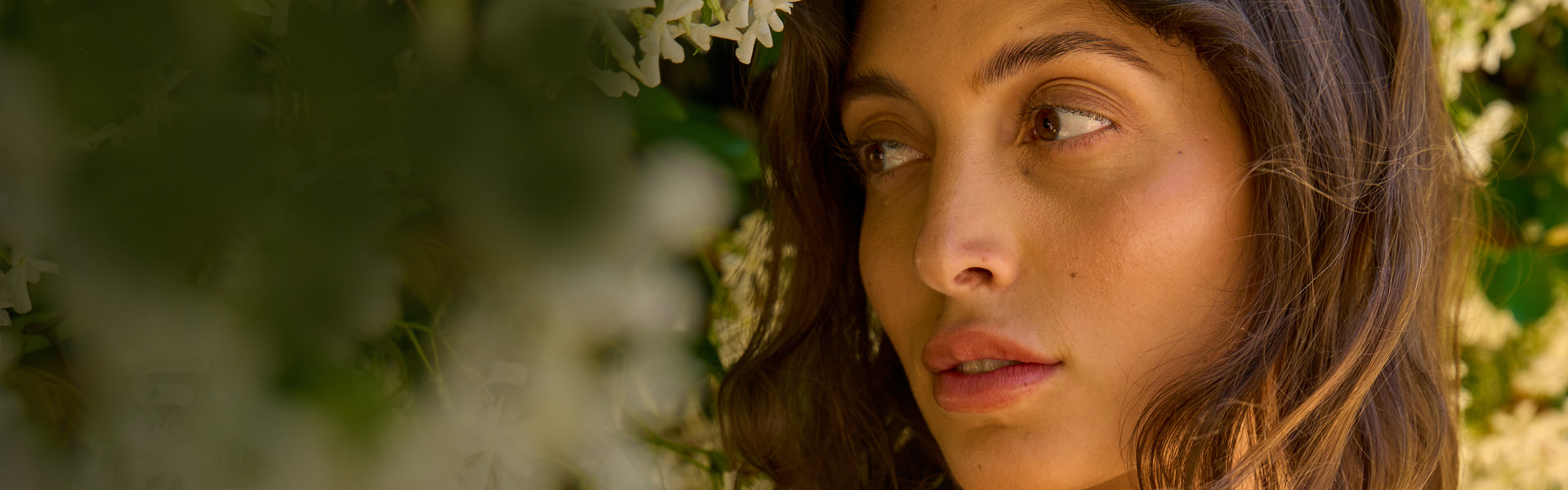 Woman with flowers in the background