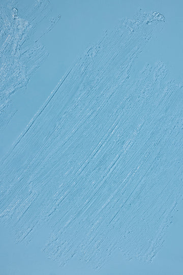 Sunscreen Invisible stick applied to a loght blue background showing texture and clear formula