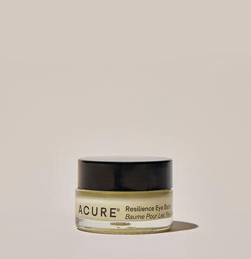 A jar of ACURE Resilience Eye Balm against a neutral background.