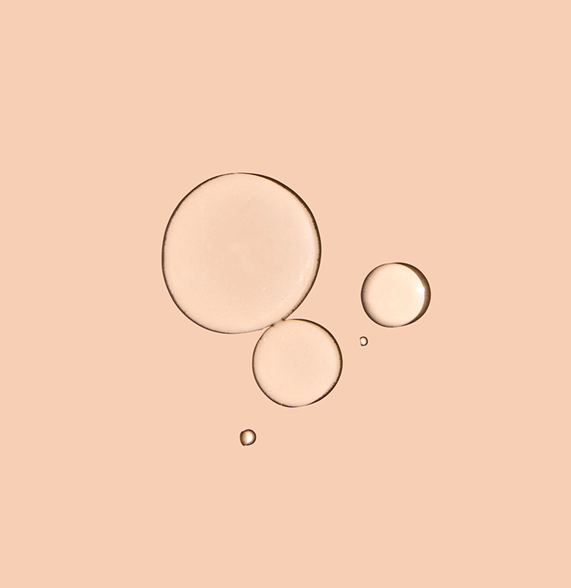 A few drops of Zombie Cell Clarifying Serum on a neutral background
