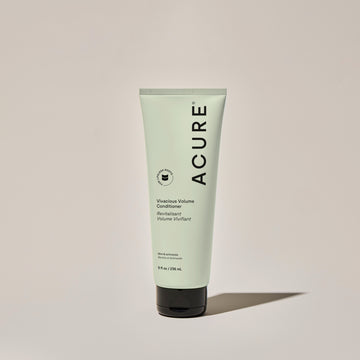 A tube of ACURE Vivacious Volume Conditioner against a neutral background.