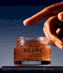 Hand taking Zombie Cell Clarifying Mask out of the jar