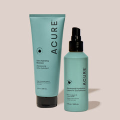 Acure shampoo and conditioner bottles on a beige background