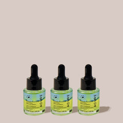 Three bottles of ACURE serum on a beige background