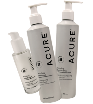 Acure hair care product bottles on a white background