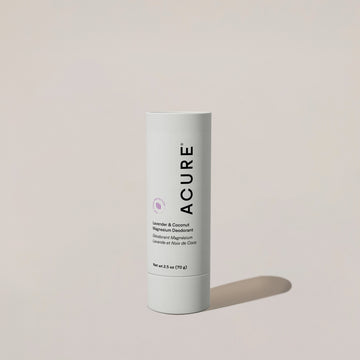 A white cylindrical container of ACURE Magnesium Deodorant with lavender and coconut, featuring product information and branding.