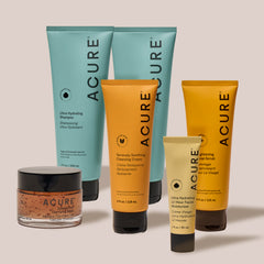 Acure products for hair and skin care on a neutral background