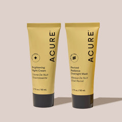 Two tubes of Acure skincare products on a light background